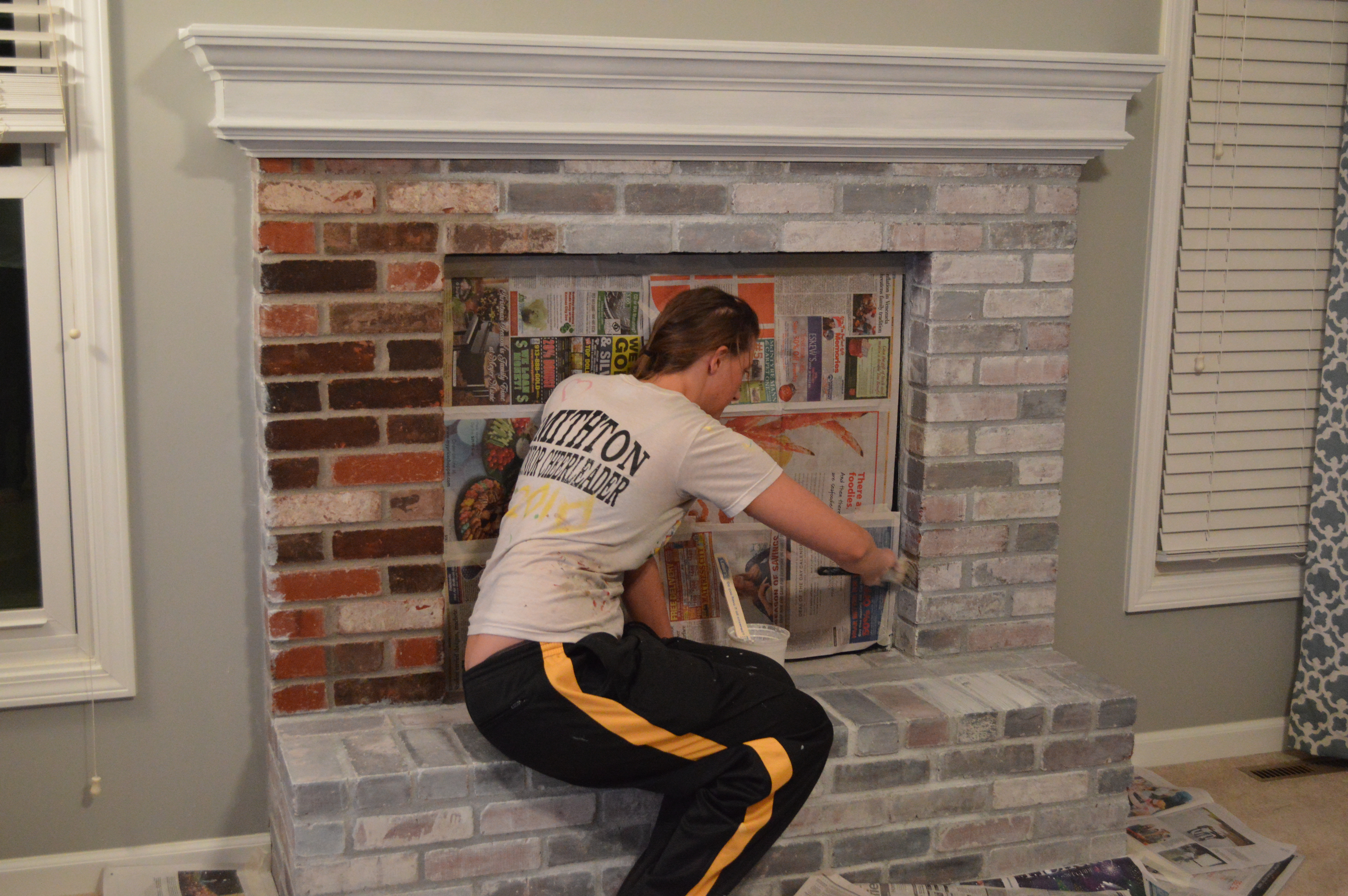 The ultimate step-by-step tutorial for how to whitewash brick and transform a dated fireplace with an easy